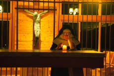 Mother Therese lighting candles